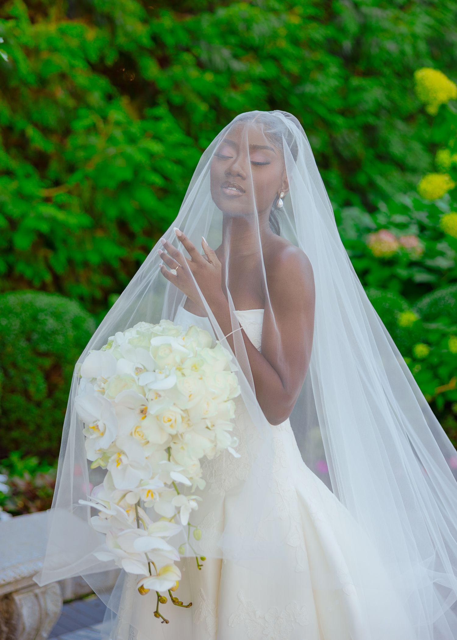 A stunning mermaid wedding gown with lace details and dramatic ruffled train on display.