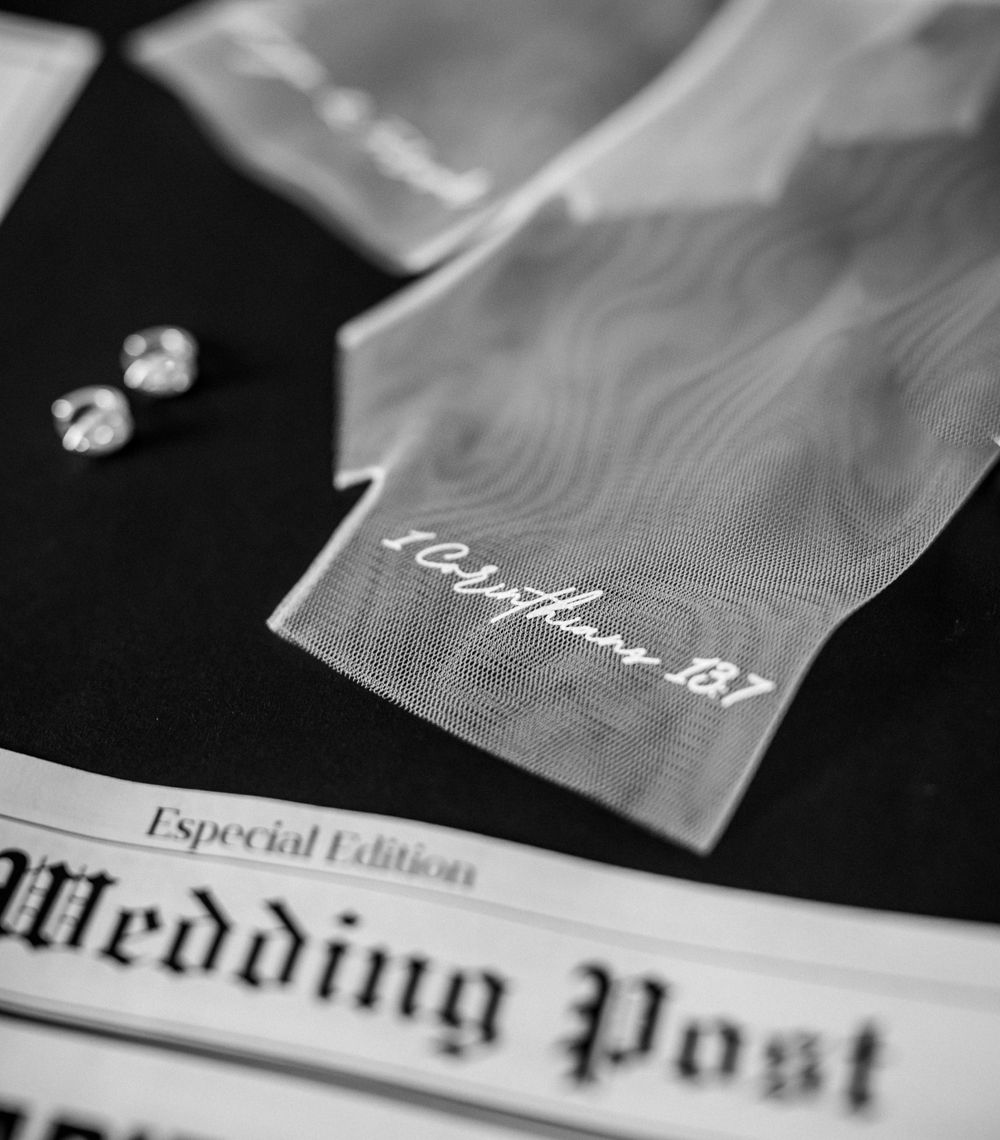 Detail shots of printed wedding invitations and paper goods in black and white.