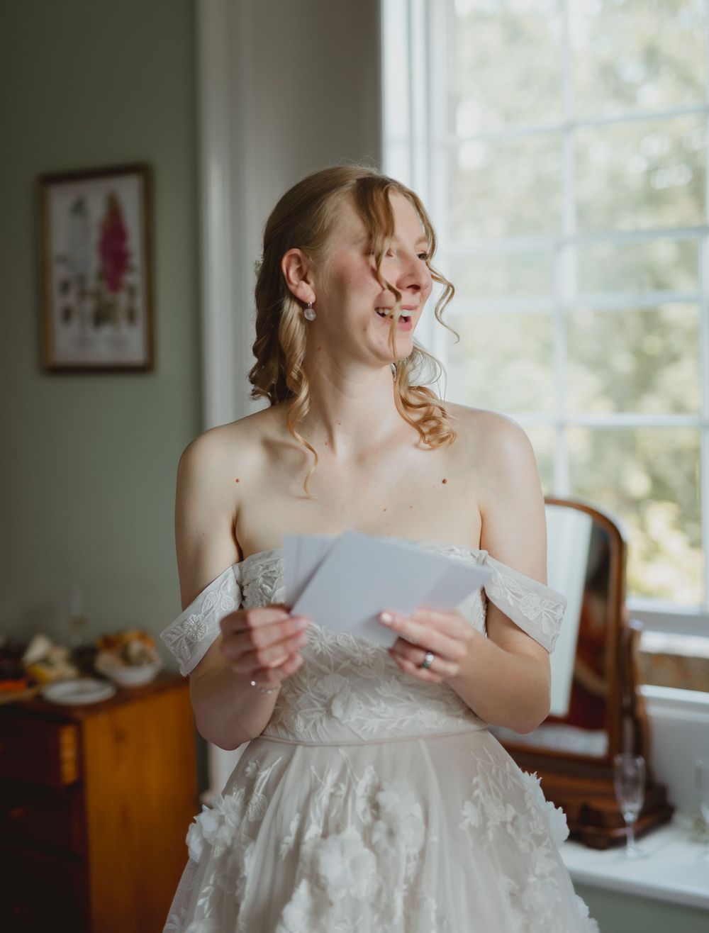 A sequence of four photos shows a bride putting on her elegant off-shoulder white wedding dress in a sunlit room.
