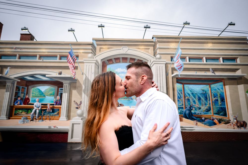 A tender embrace captured in an elegant indoor setting with ornate architectural details.