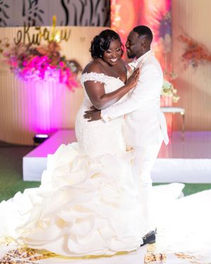 Couple in white formal attire share romantic moments on the dance floor.