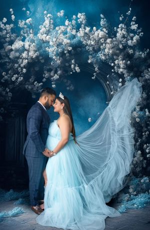 Romantic wedding portrait under cherry blossoms with flowing blue gown and veil.