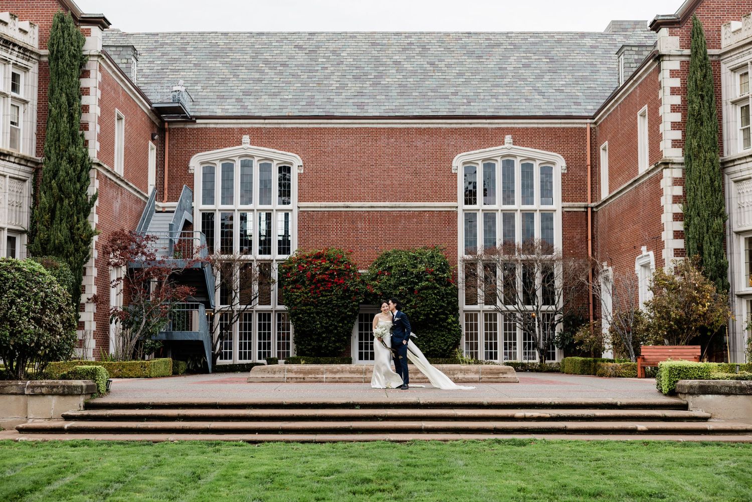 Wedding photo of bride and groom standing in front of Khol Mansion wedding venue at San Francisco