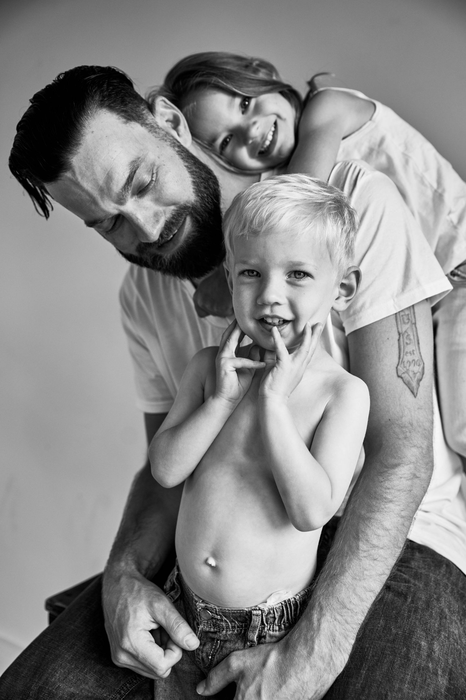 Black and white portrait series showing playful candid moments between parent and child.