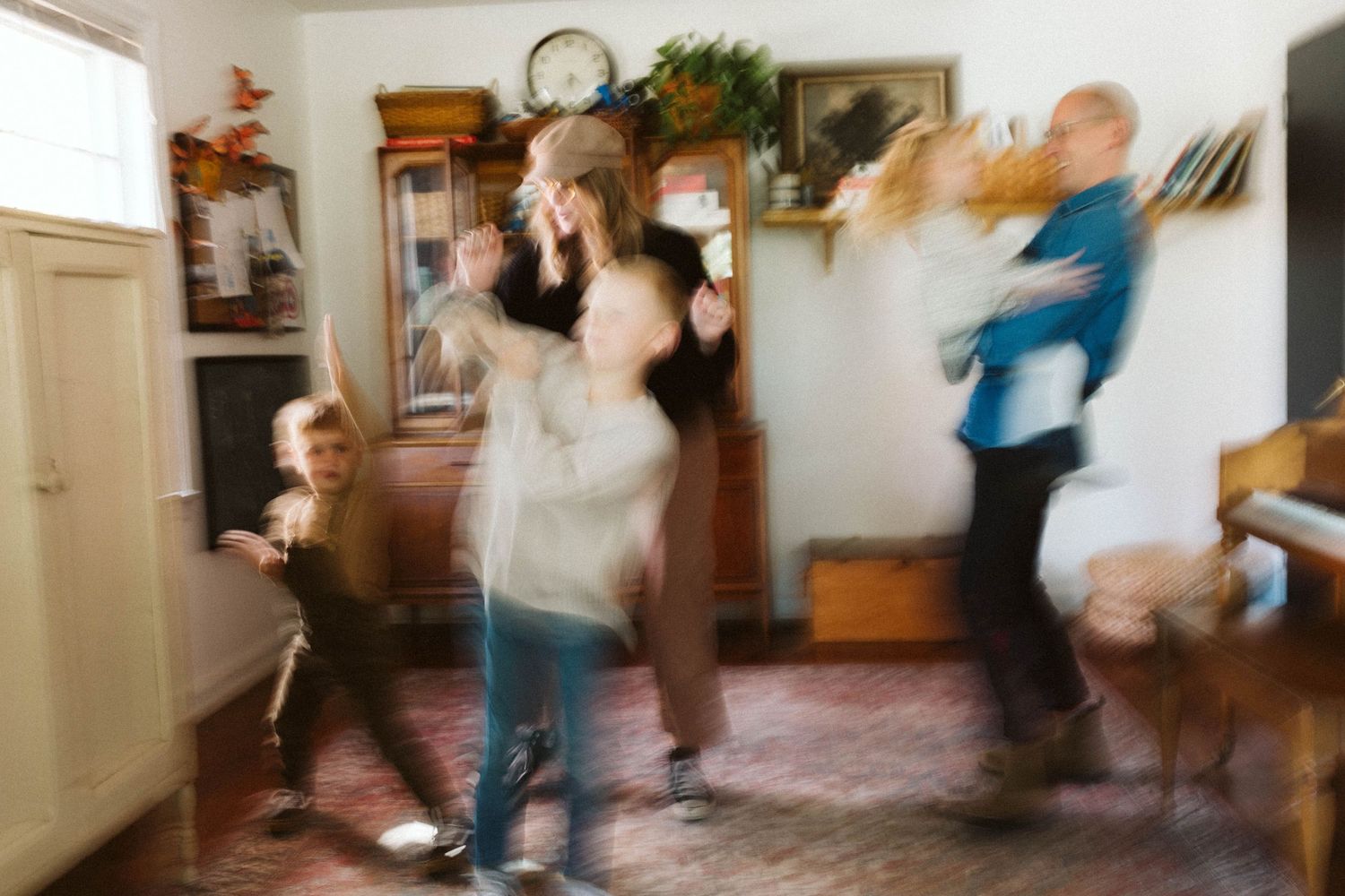 Motion blurred photo by B. Logsdon of Savannah, GA of people dancing energetically in a home living room.