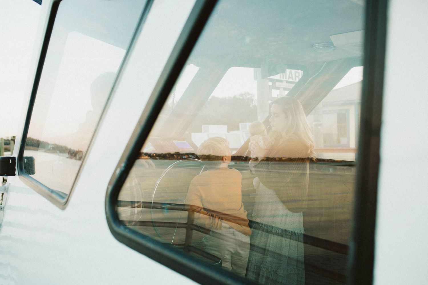Reflective boat window view during a sunset photoshoot with B. Logsdon Photography on the May River of Bluffton, South Carolina.