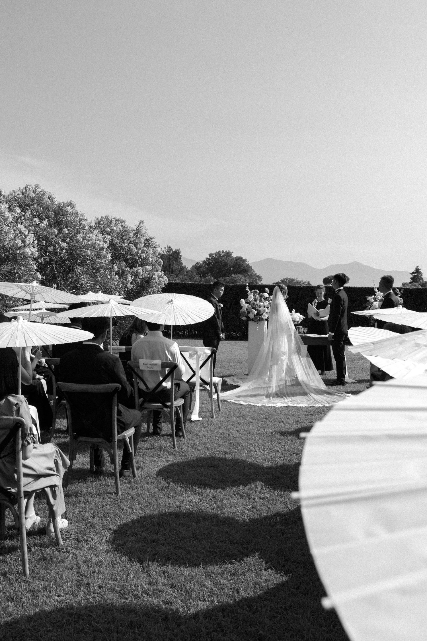 Stylish black and white wedding ceremony in Tuscany, Italy, capturing the couple and their guests in an elegant outdoor setting