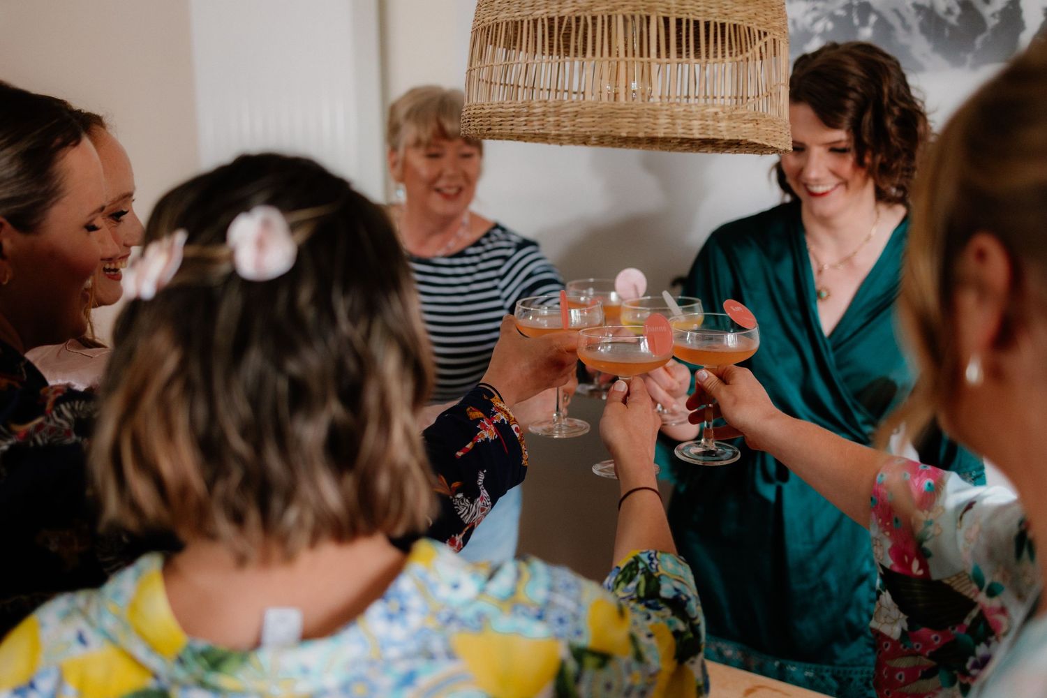 Wedding party raises glasses in a toast during celebration.