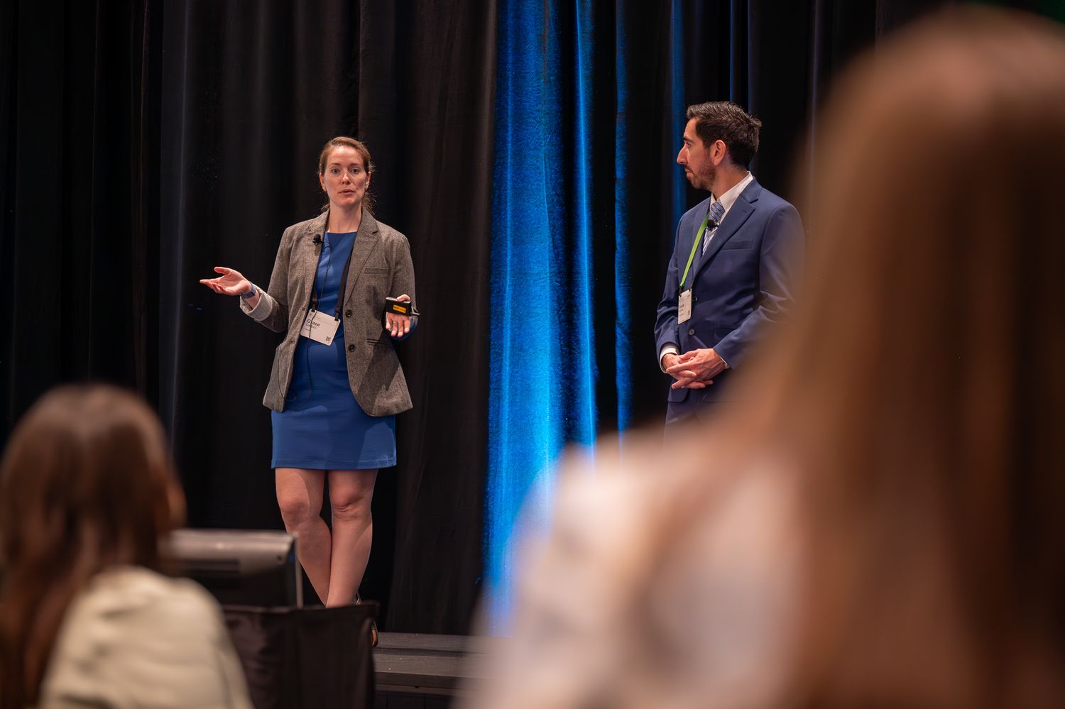 Two speakers onstage at the Enablon 2024 conference in Houston, TX.