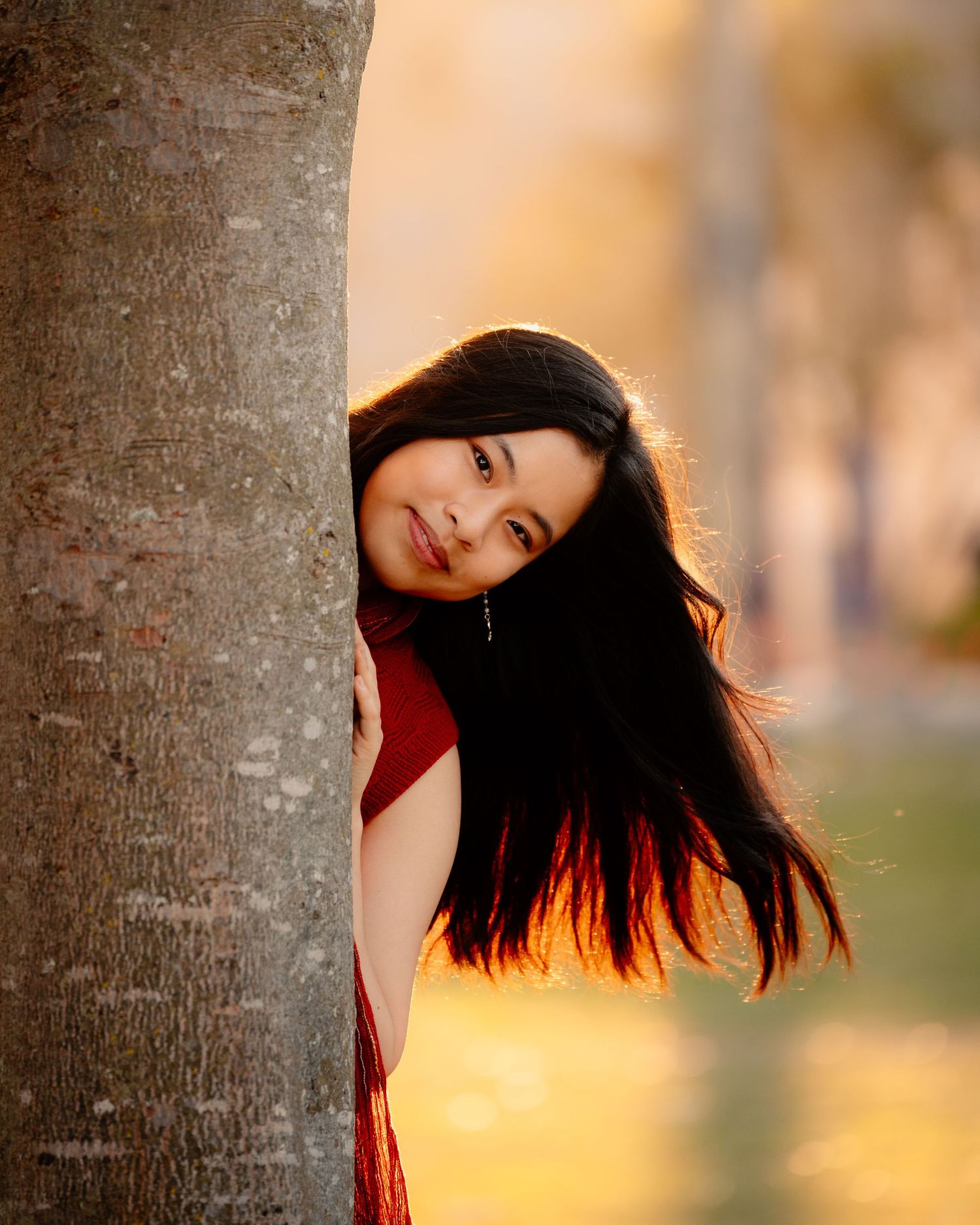 A vintage-style portrait featuring a camera and floral dress against pampas grass decor.