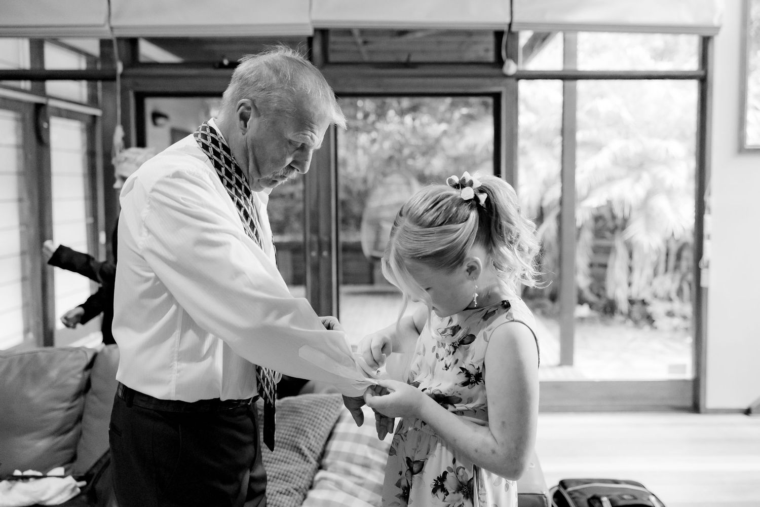 A touching black and white moment during wedding preparations indoors.