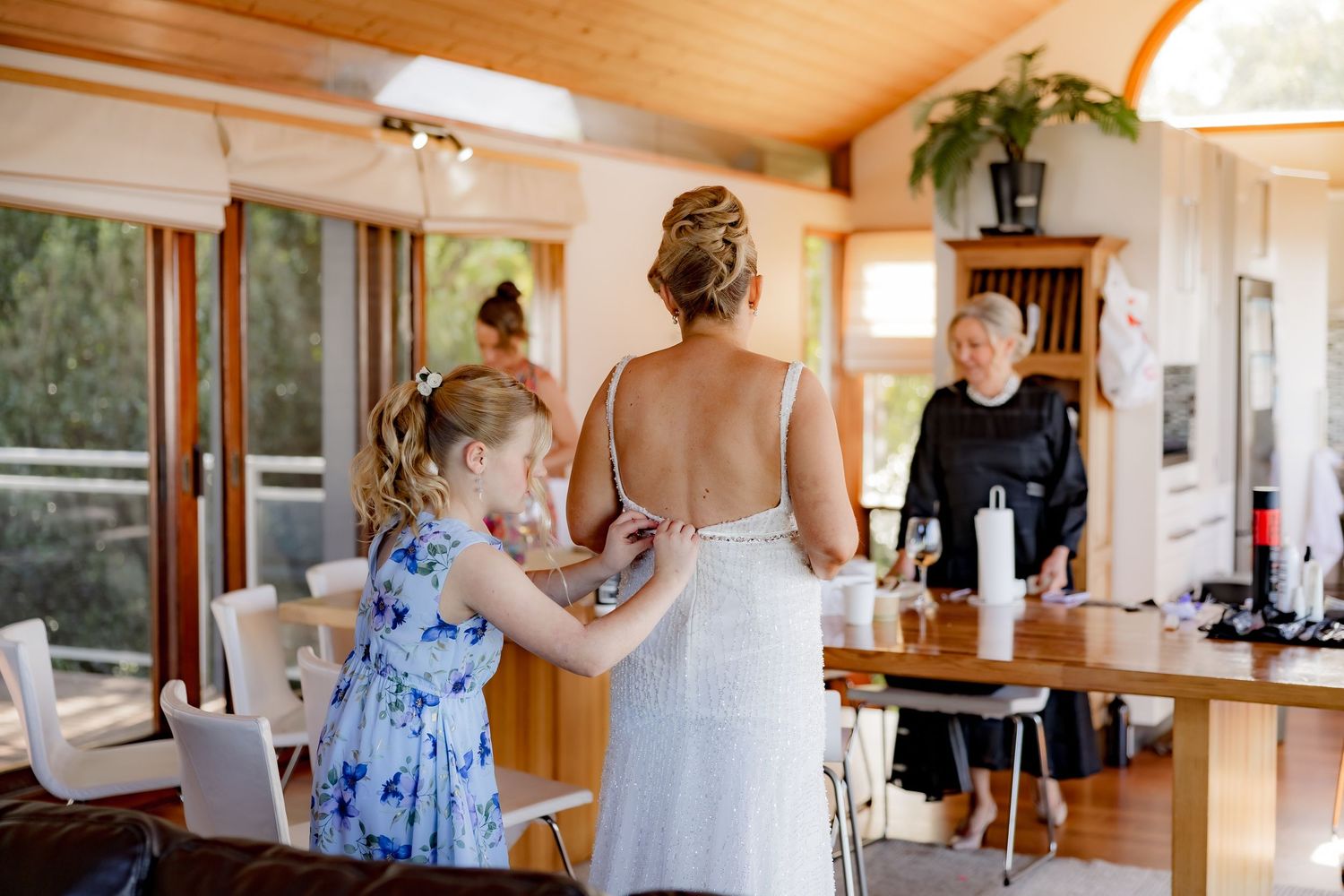 A wedding preparation scene in a bright modern room with wooden details.