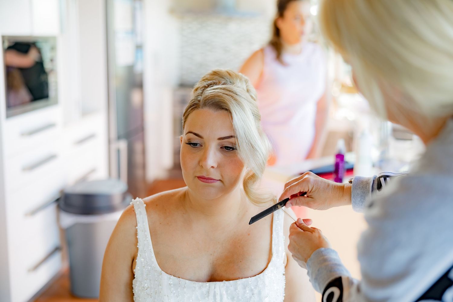 A quiet moment during wedding day makeup preparations.
