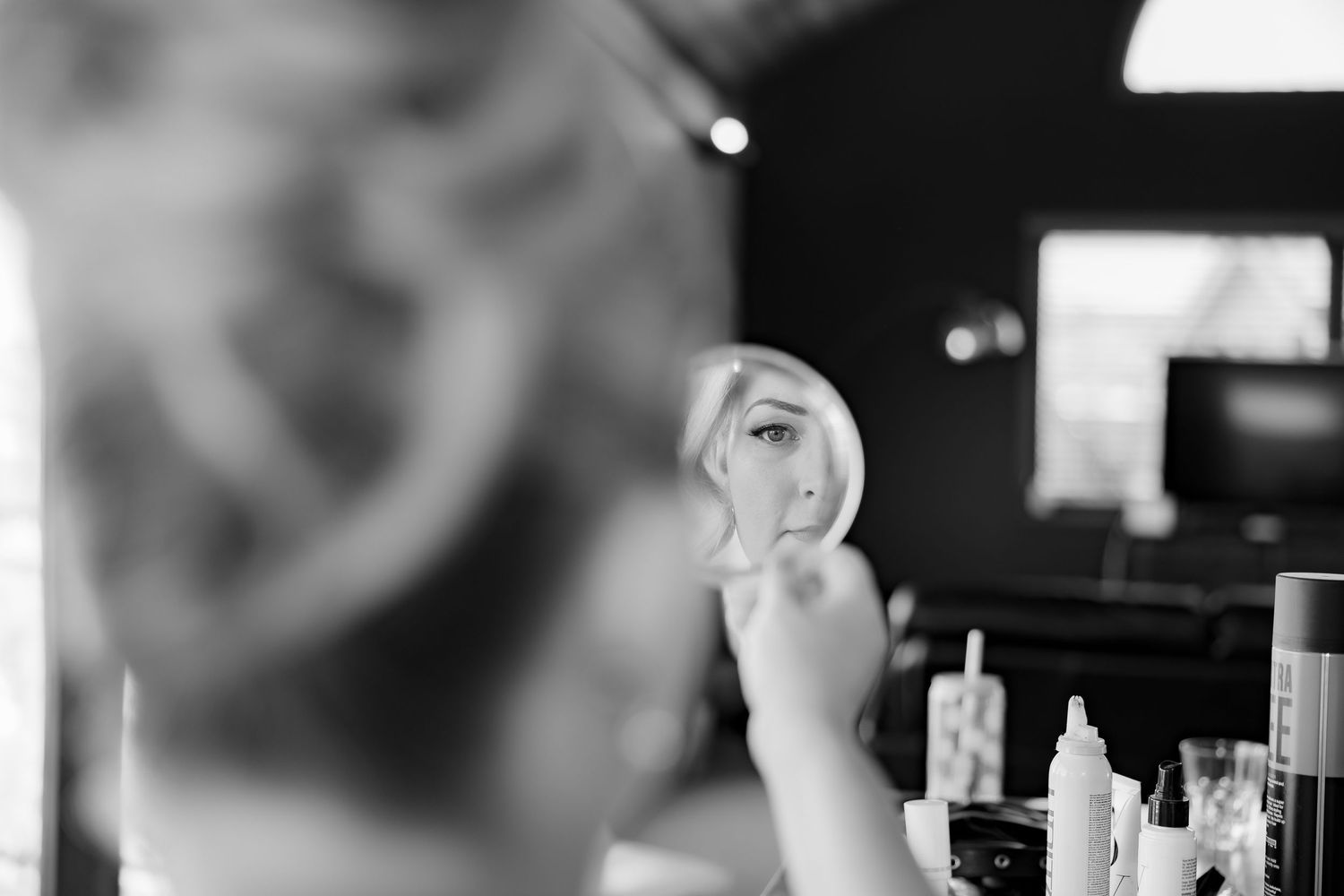 A black and white reflection captured during wedding preparations.
