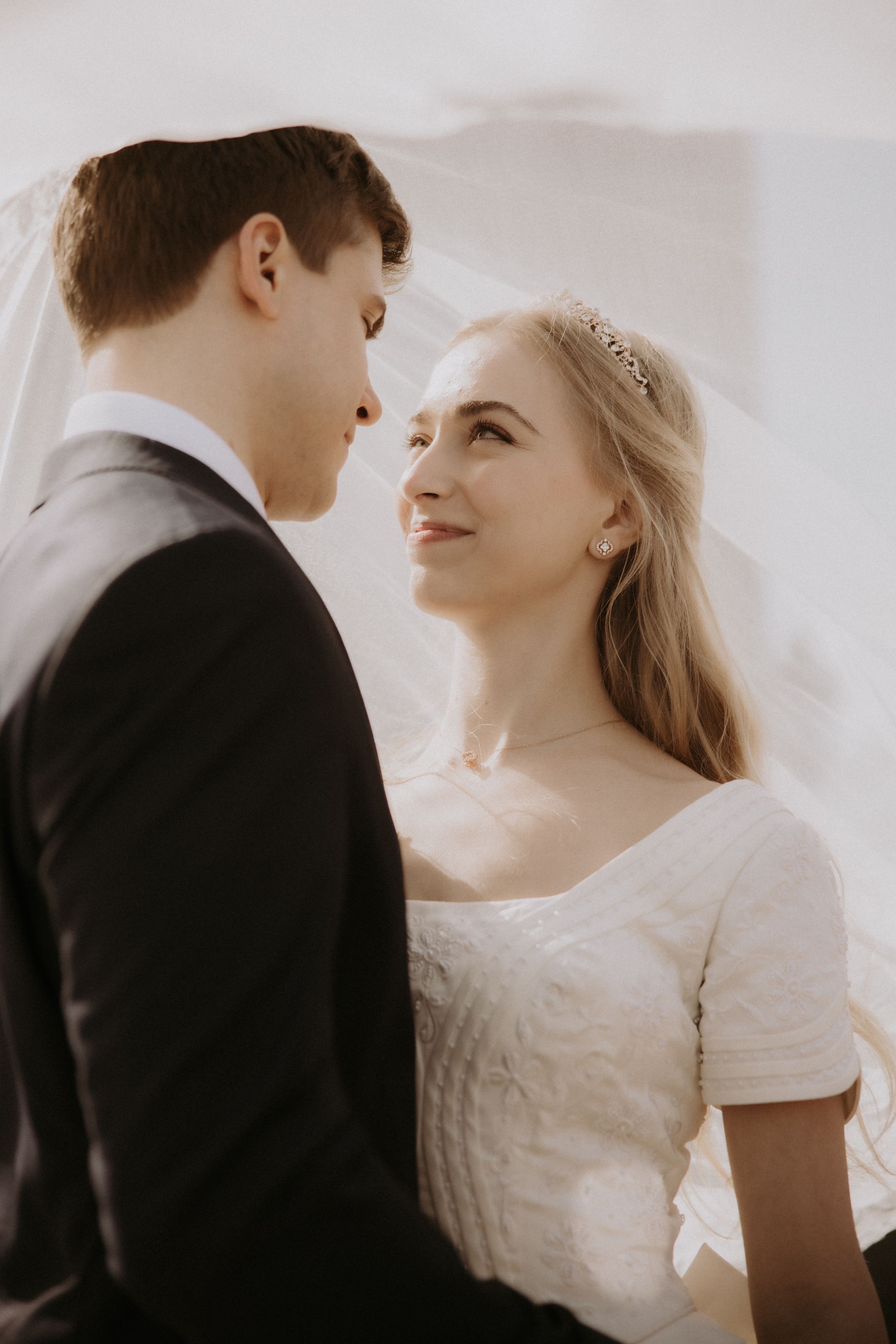 Romantic wedding couple shares intimate moments in a series of soft, ethereal black and white portraits.