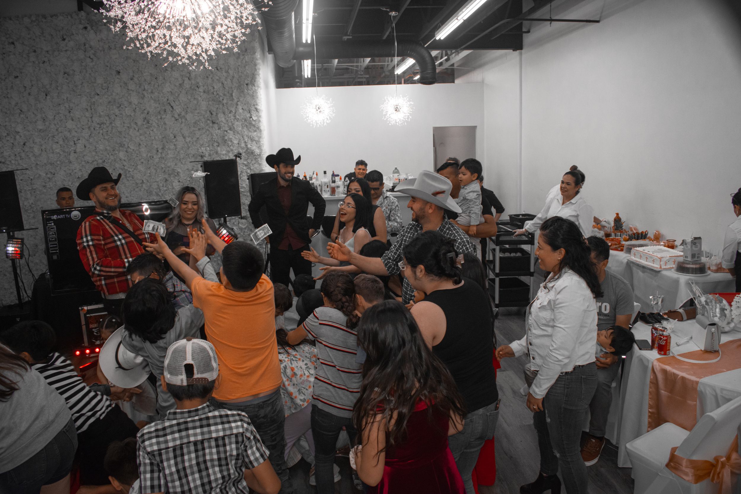 Lively party scene with guests dancing and celebrating in an industrial-style venue.