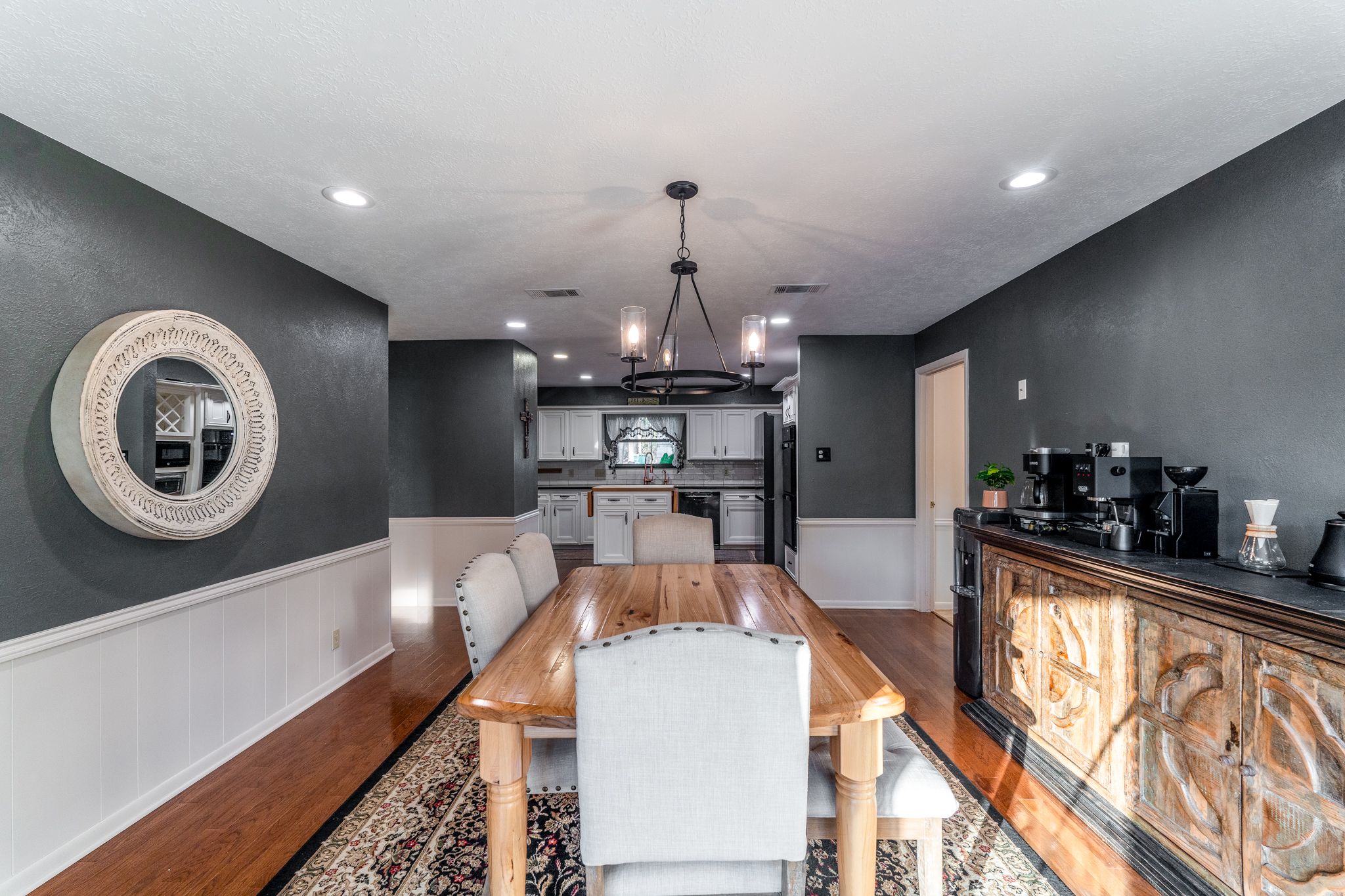 Modern basement renovation features recessed lighting, grey walls, and contemporary furniture in an open concept layout.