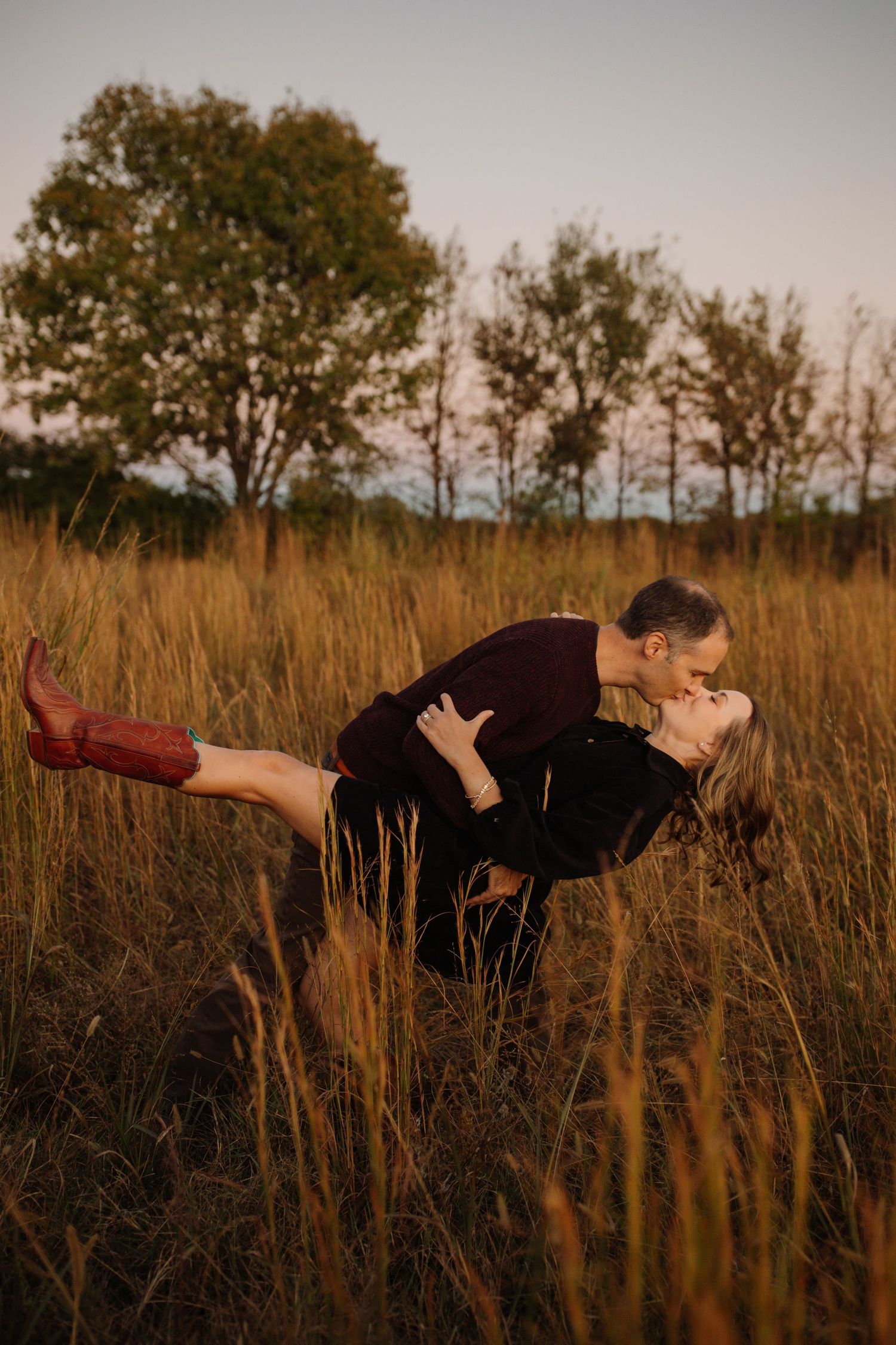 Person floating horizontally above tall grass field at sunset in artistic levitation photography series.