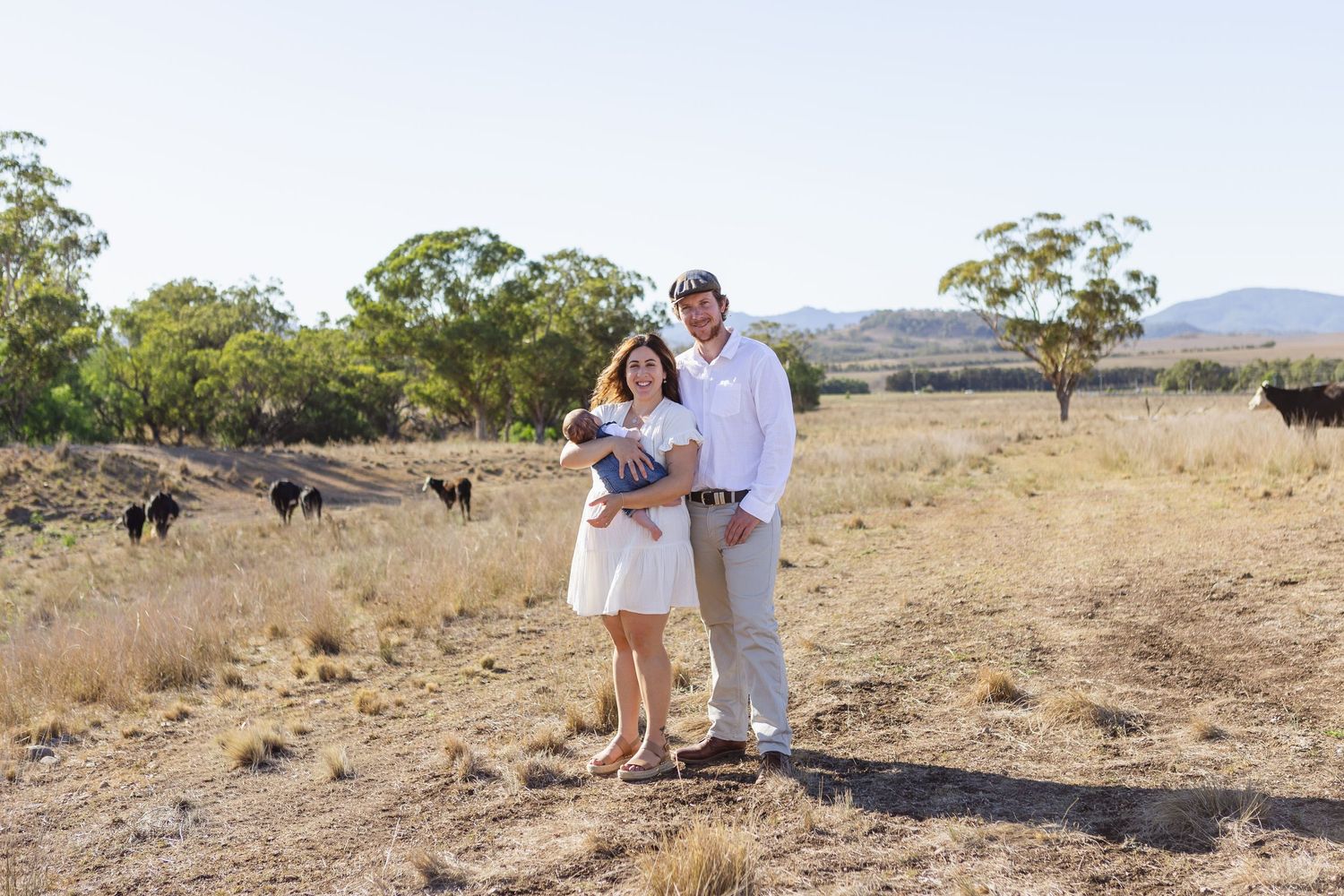mum holding newborn baby and dad cuddling mum at scone family photoshoot