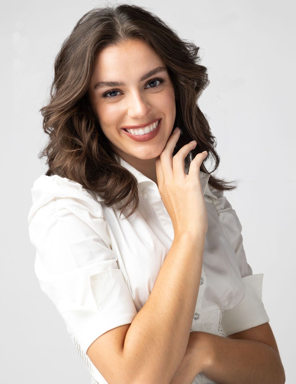Studio headshots featuring casual white shirt and natural poses against light background.