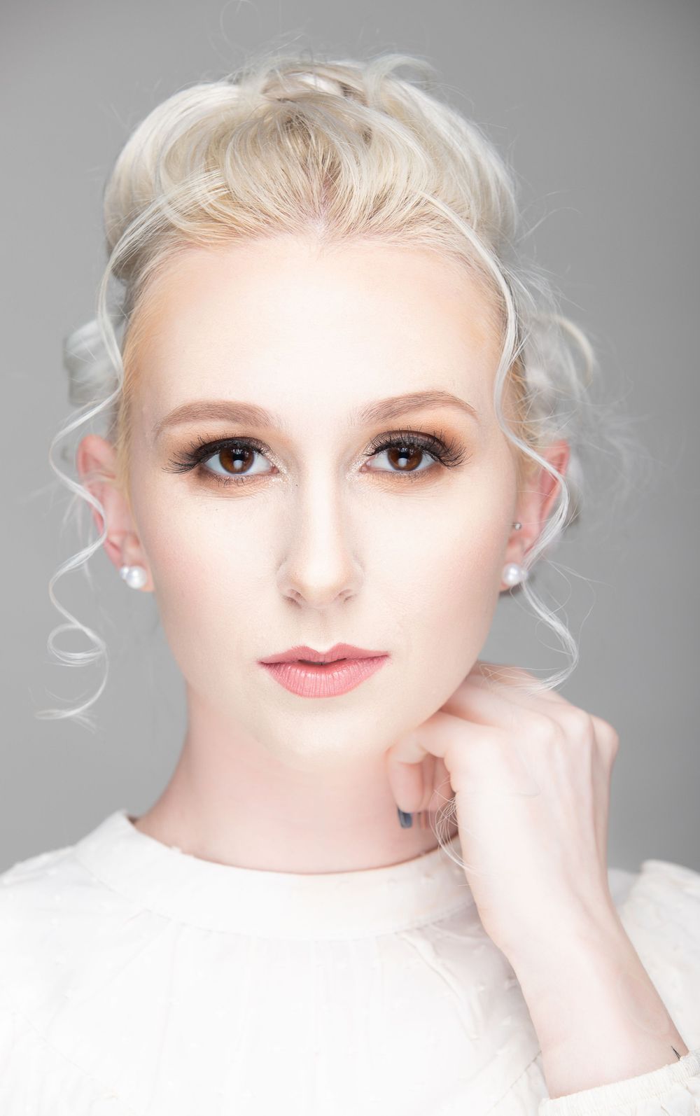 High-key beauty portrait series with platinum blonde hair against light gray background.