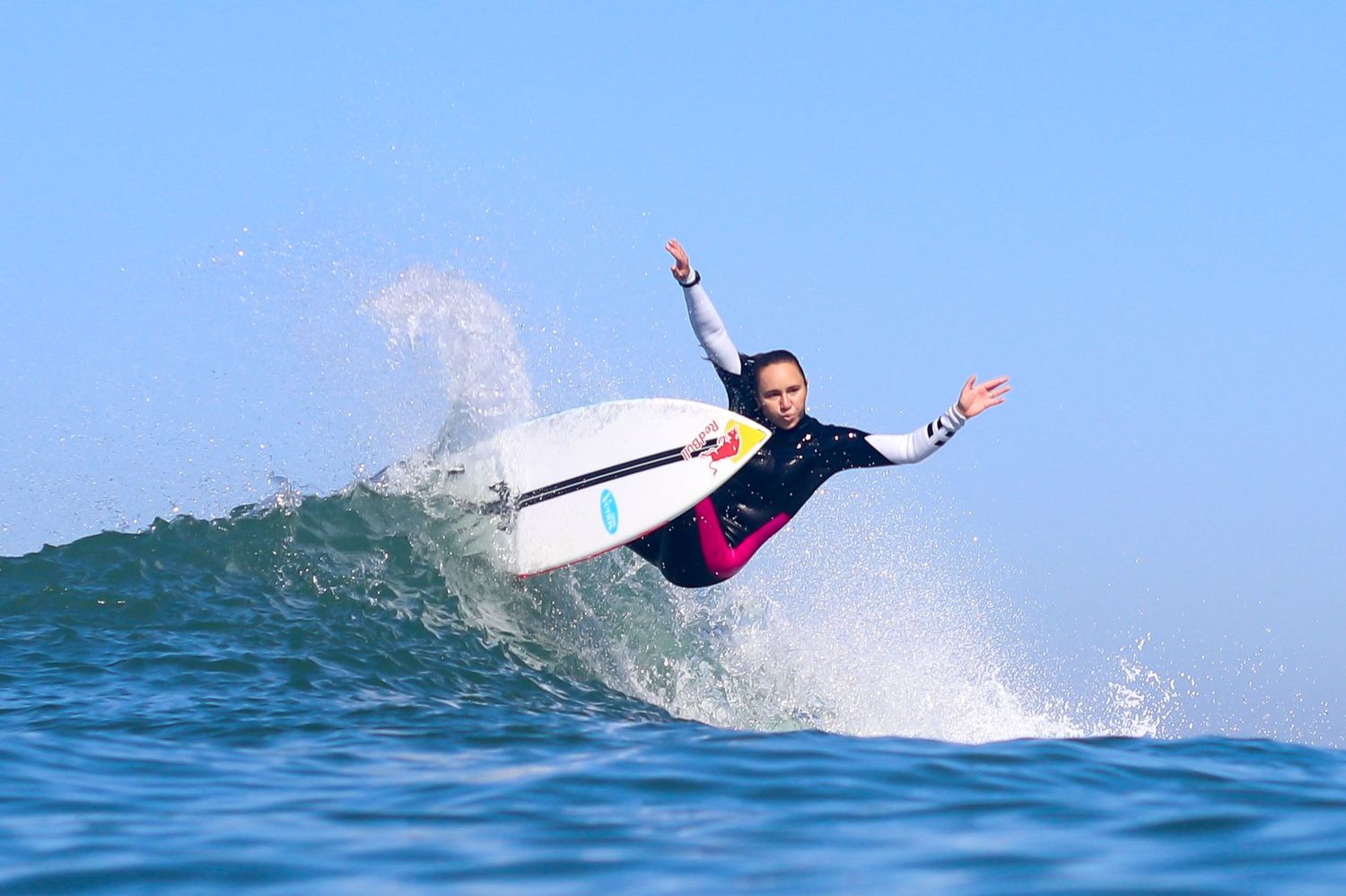 Trestles surf photography of professional surfer Carissa Moore carving a wave on a Red Bull surfboard.