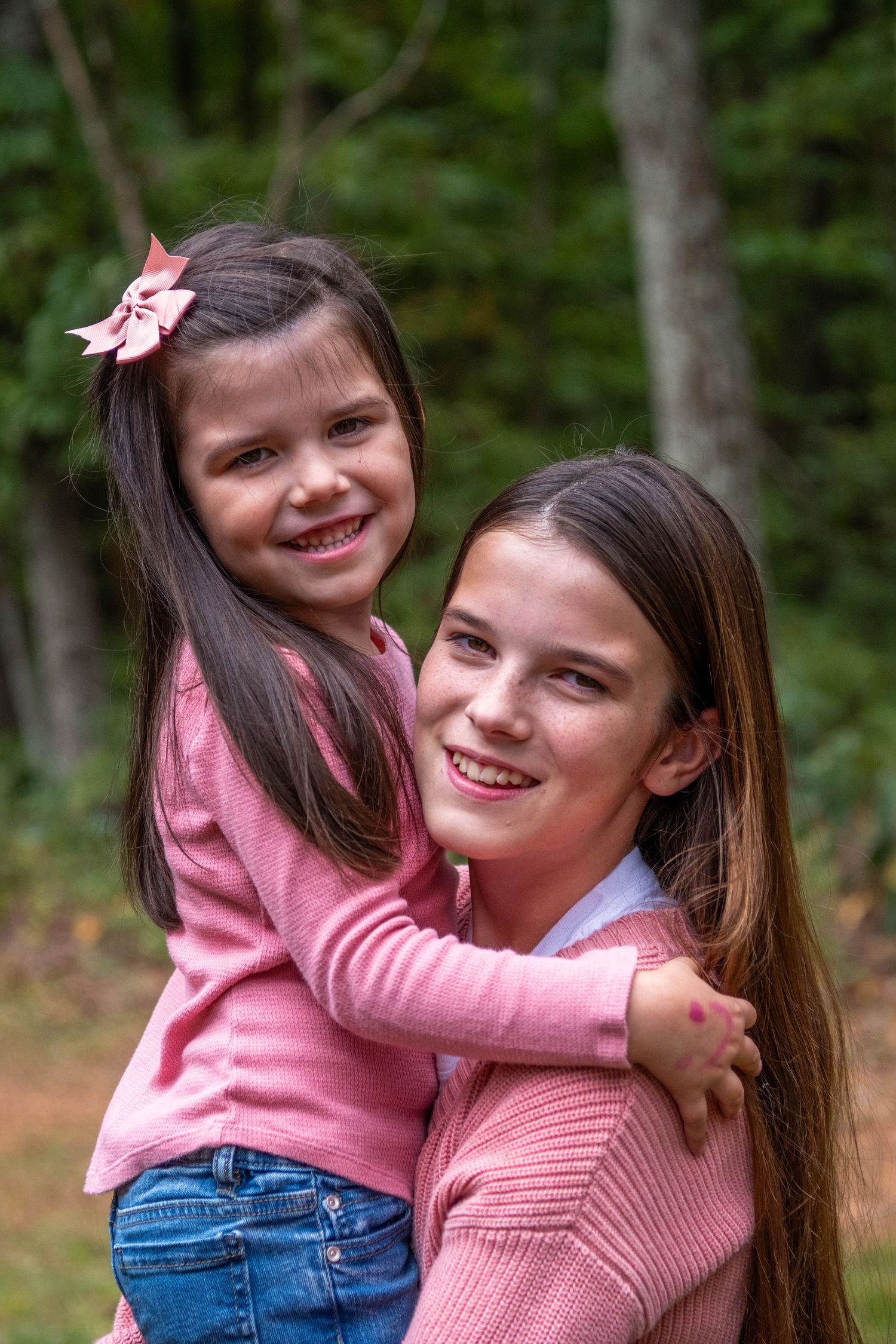 A sweet moment captured in a series of photos showing affectionate hugs and smiles in matching pink outfits outdoors.