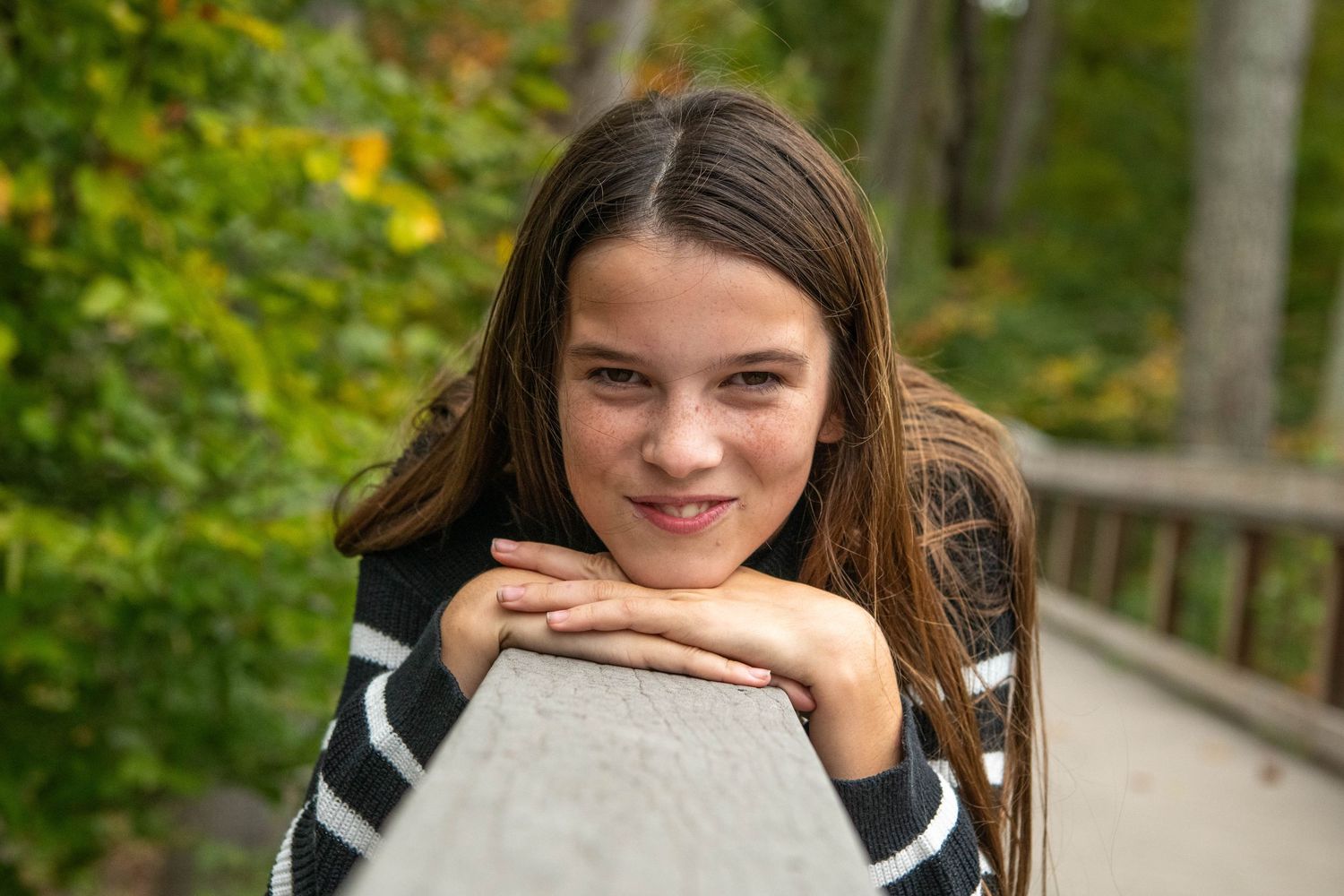 A series of outdoor portraits showing someone in a gray sweater against a blurred green background.