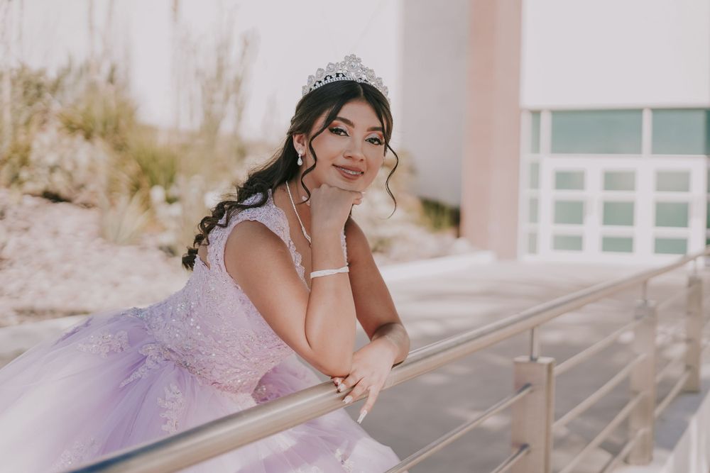 A dreamy lavender quinceanera dress photographed on a sun-lit balcony.