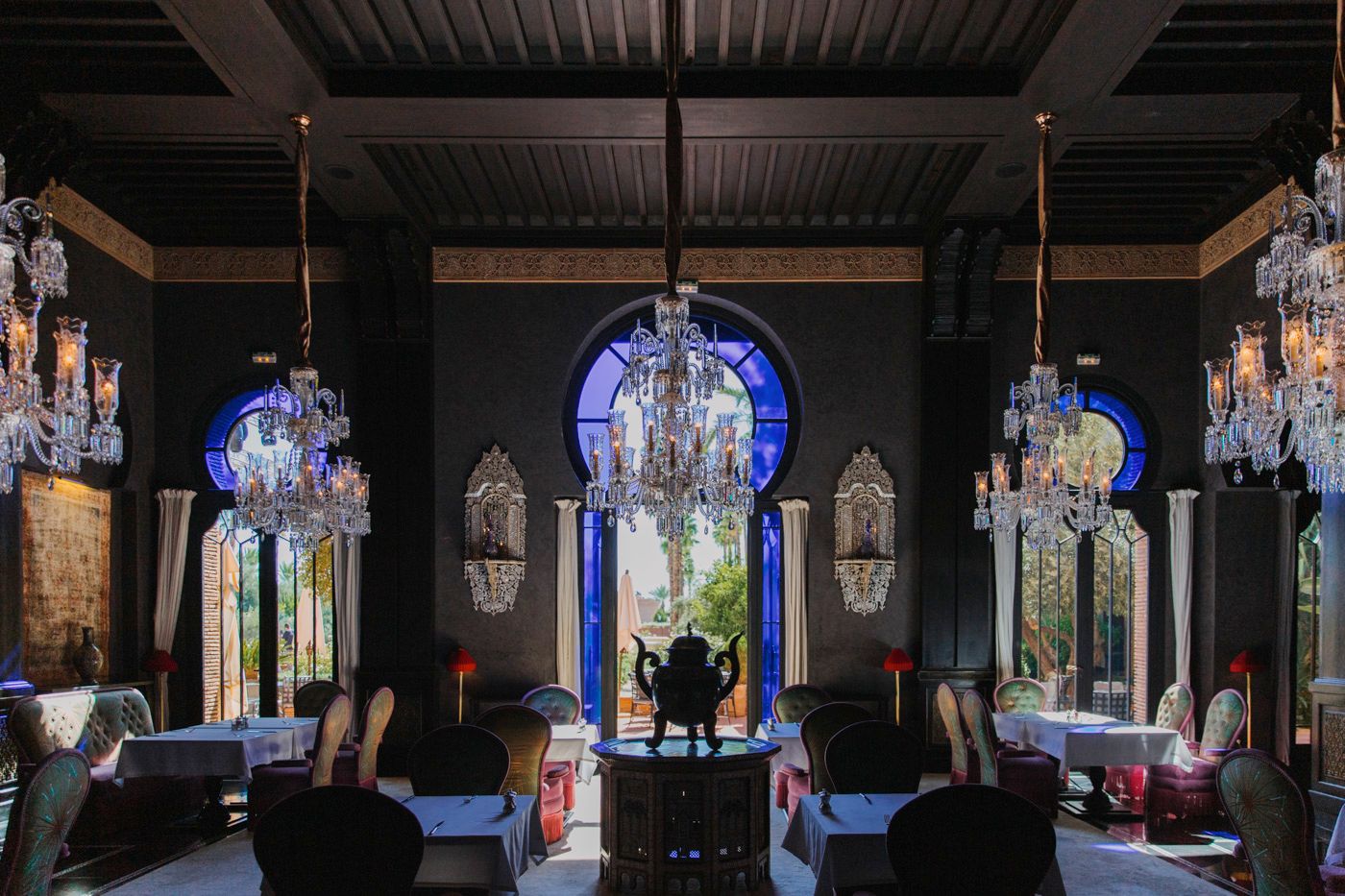 Opulent dining room with Moorish arches, crystal chandeliers and elegant furnishings.