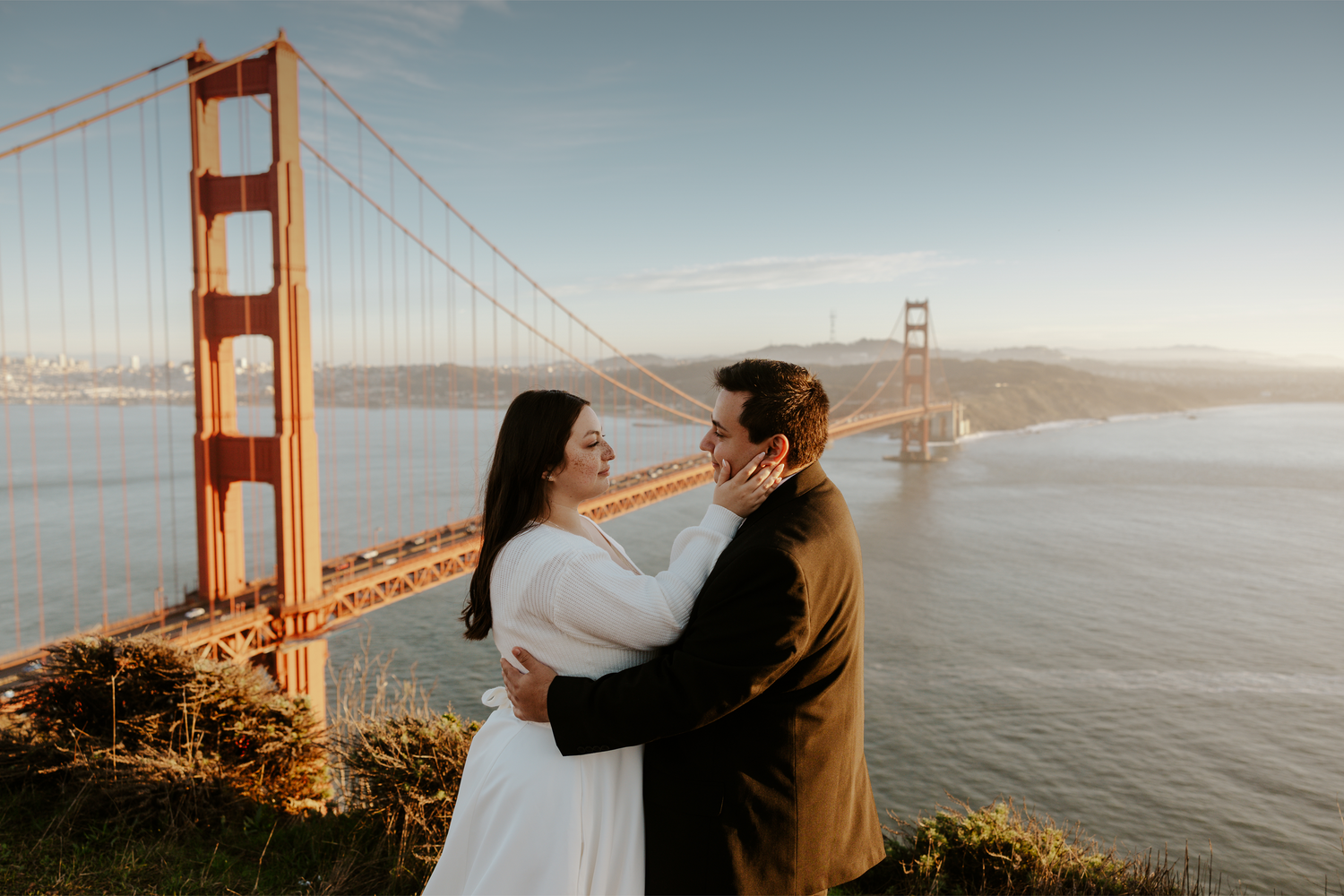 bride and groom looking at each other with the Golden Gate Bridge in the background on their San Francisco Bay Area elopement day