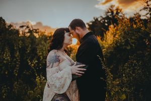 A couple embraces in golden sunlight among autumn foliage. North Fort Myers Florida Photographer