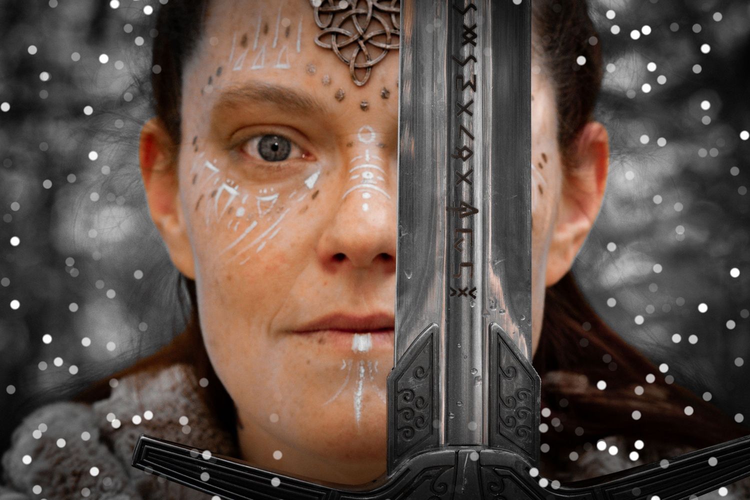A warrior woman with runic face paint holds a sword in a snowy, mystical fantasy scene.