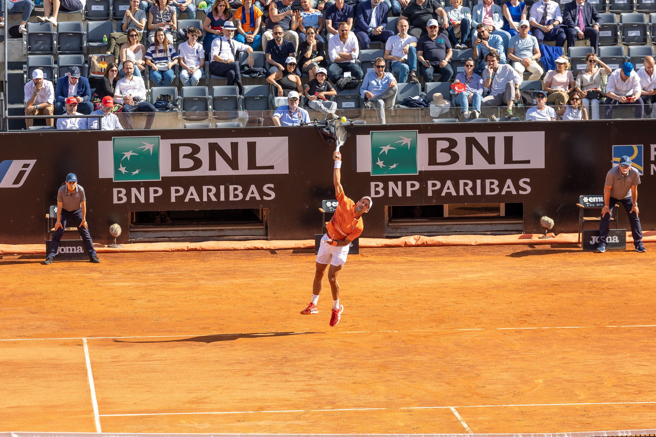 Professional tennis match on clay court at BNL tournament.