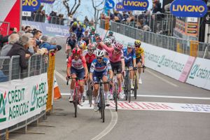 Professional cyclists sprint towards finish line during race in Livigno.