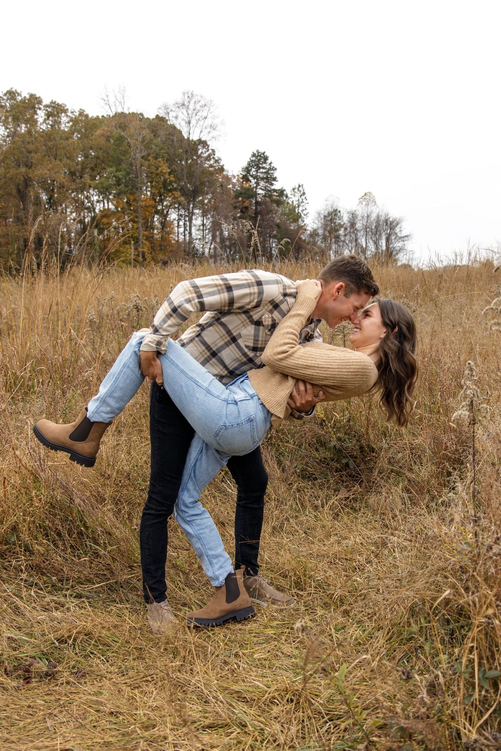Romantic dip pose captured in golden field during couple's photoshoot.