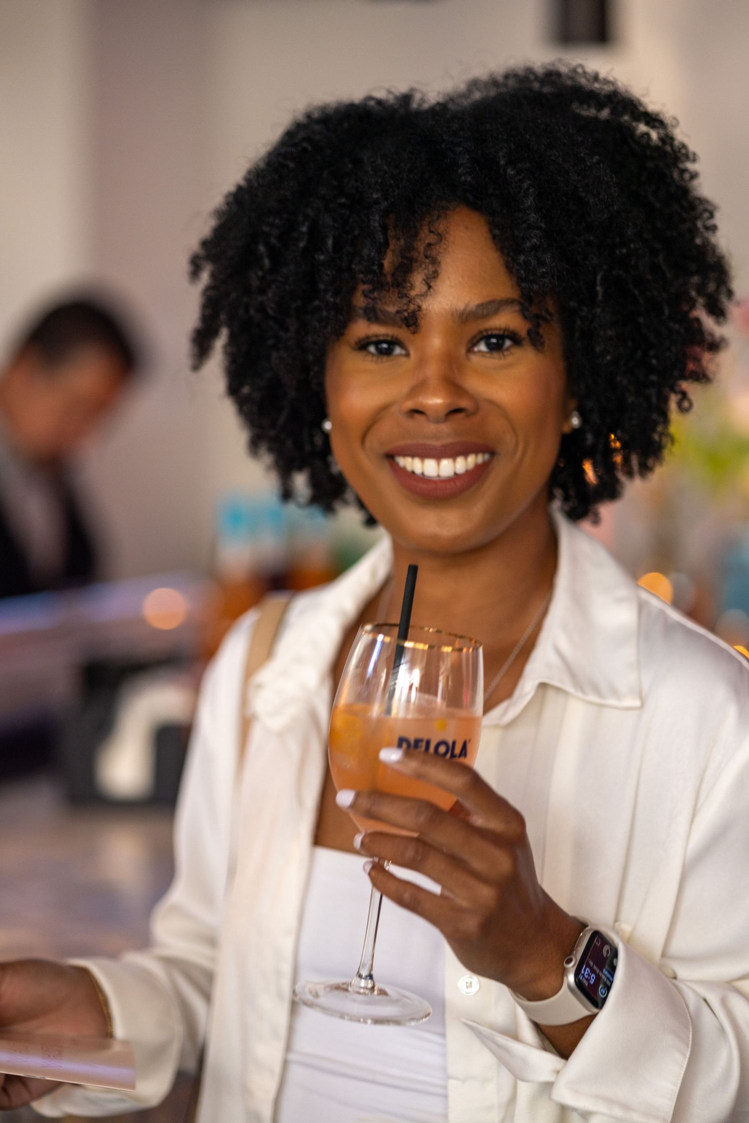 A guest enjoying a specialty cocktail at an upscale event.