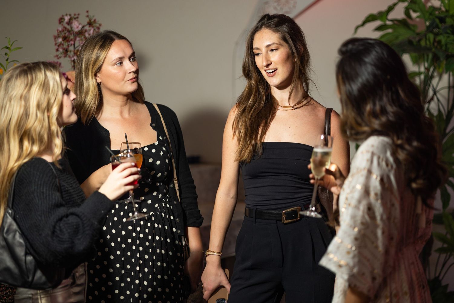 A social gathering with guests mingling and enjoying drinks.