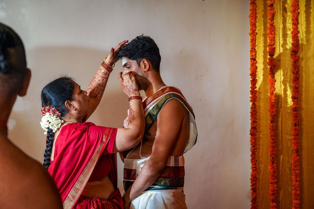 Traditional blessing ritual being performed during South Indian ceremony.