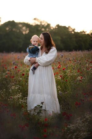 A dreamy portrait in a wildflower field at sunset with flowing white dresses.