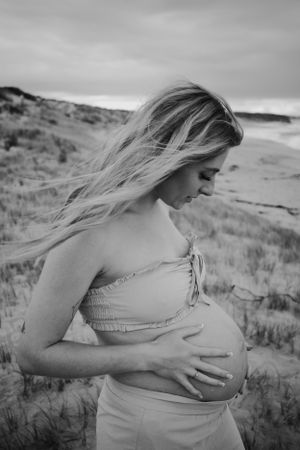 Mum looking down at her pregnant belly.
