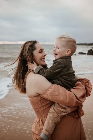 Mum and son hugging at the beach.