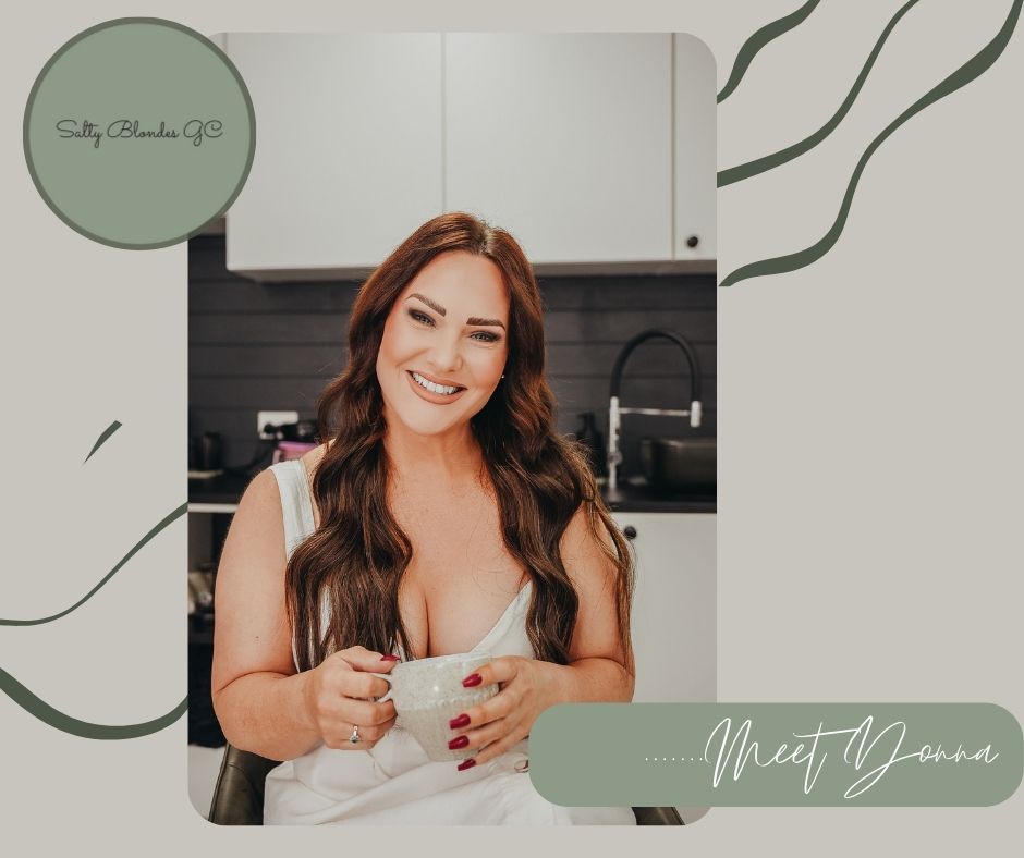 Person enjoying coffee in a bright kitchen with modern decor and sage green design elements.