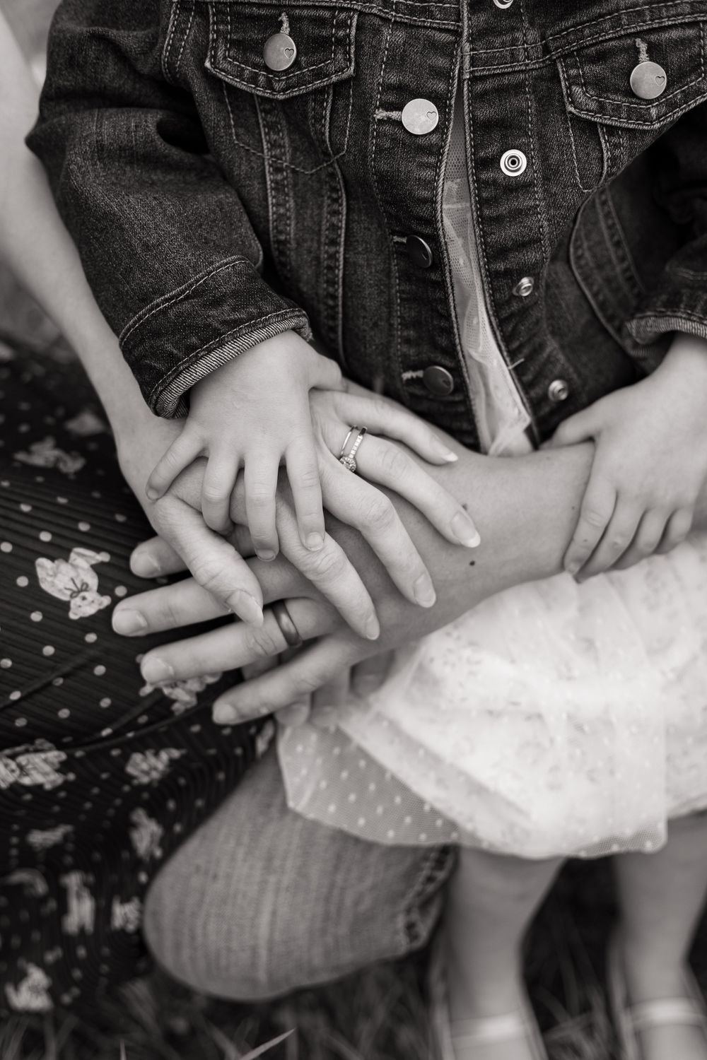 Black and white close-up of hands resting on tulle fabric.