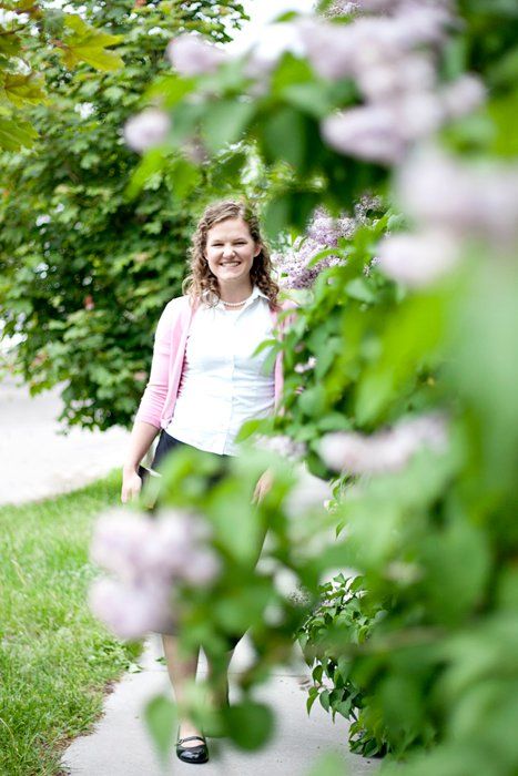 Spring blossoms frame a pathway through lush garden greenery.