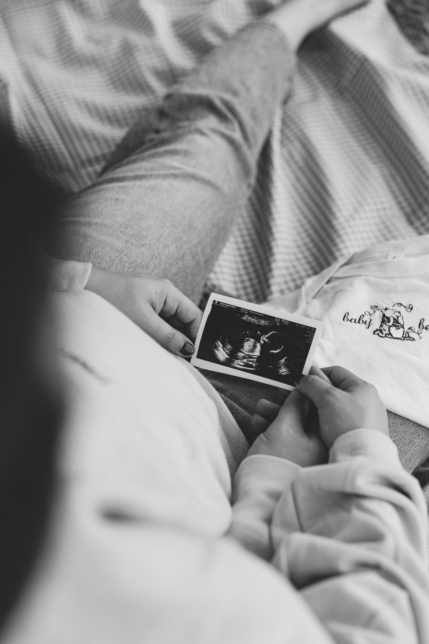 Close-up sequence of hands holding and reading a book on a floral print fabric. Luxury wedding photographer North Carolina