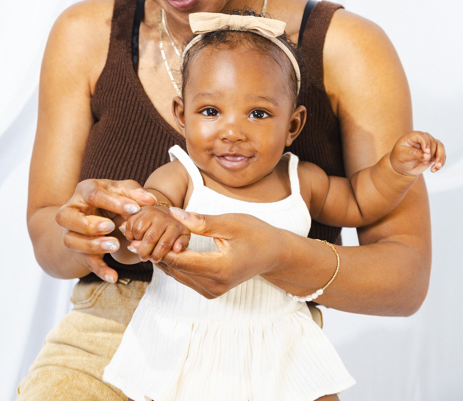 Close-up shots showing tender moments between parent and child in neutral tones.
