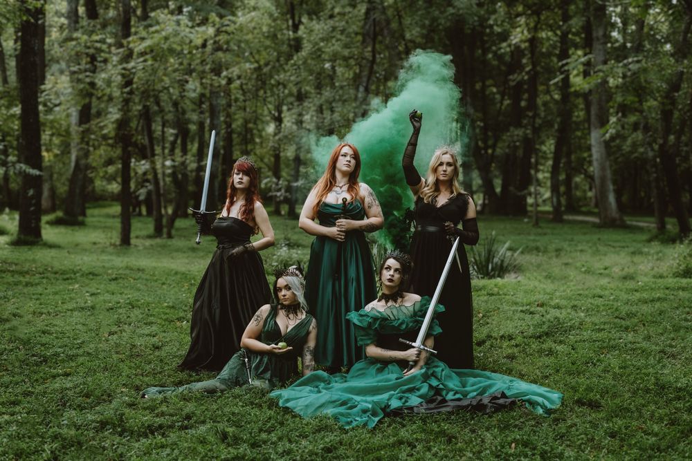 Creative poisoned apple photoshoot with models in dark costumes and cauldron smoke, Asheville, North Carolina.