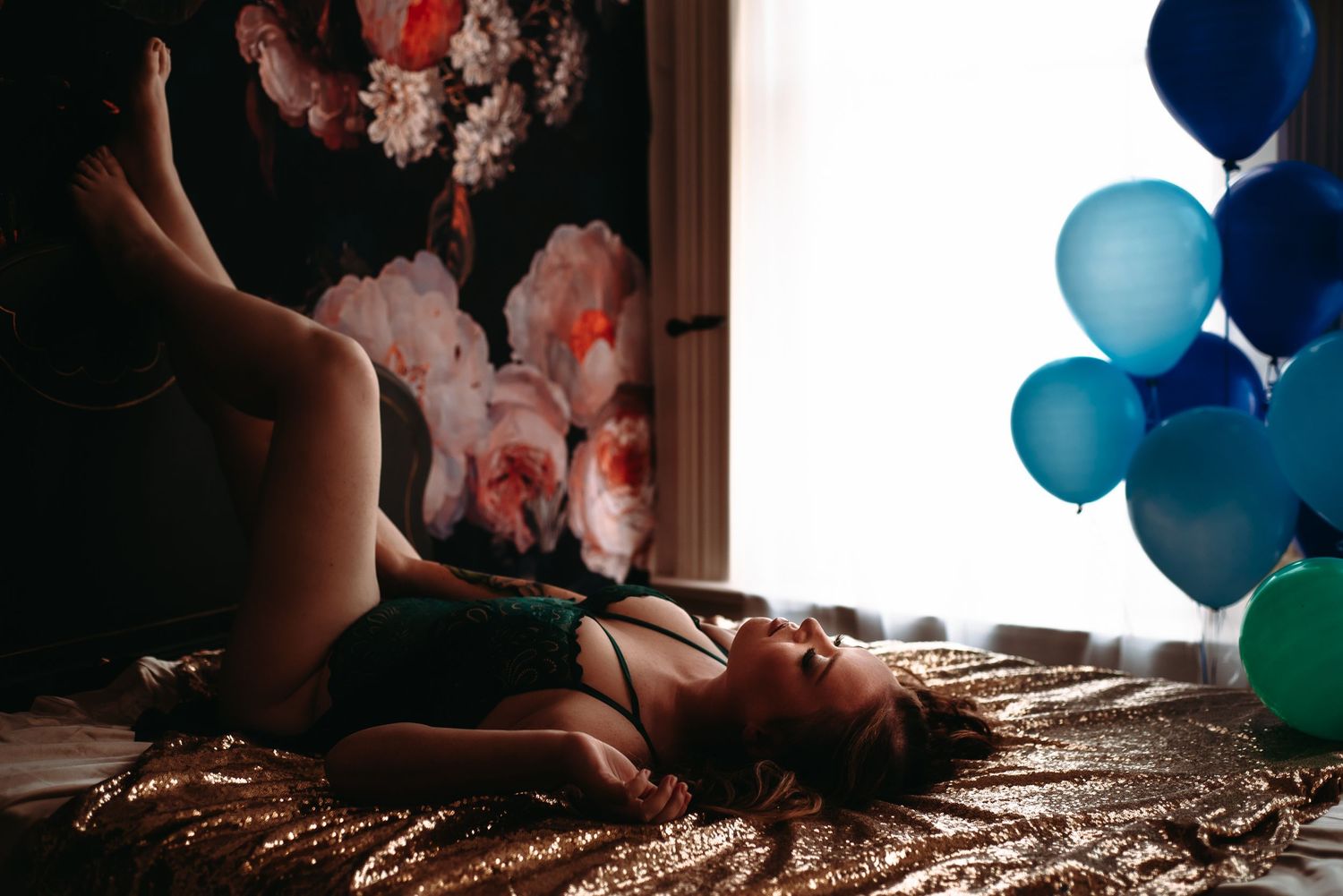A sequence of photos showing someone holding candled cake while blue and teal balloons float in the dark background.