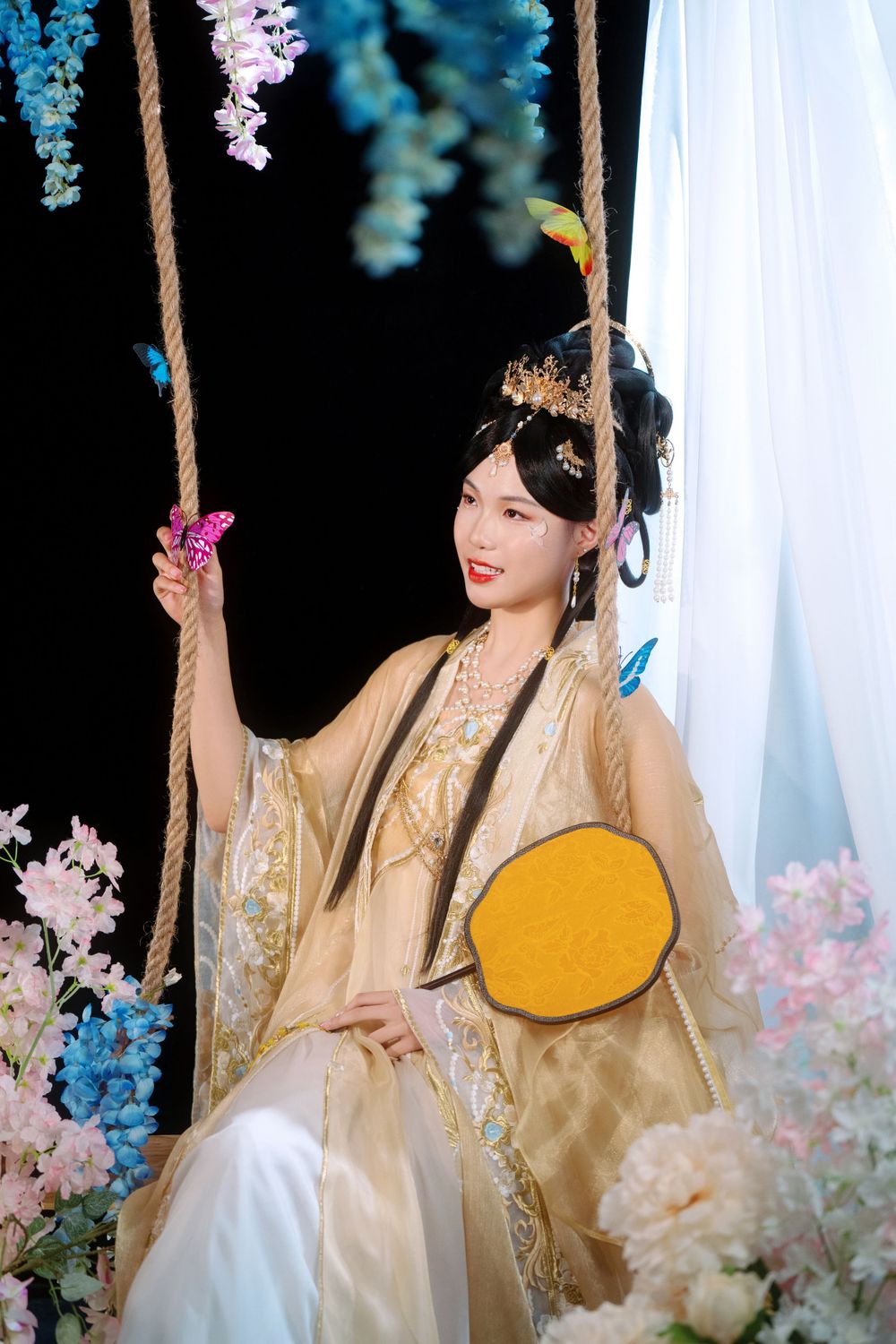 Elegant backlit studio portrait of mother and daughter in Tang Dynasty Hanfu on a swing among wisteria, by Imagine Image Studio.